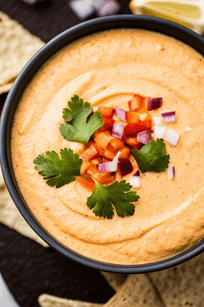 Creamy Easy Cottage Cheese Queso served in a bowl with tortilla chips on the side