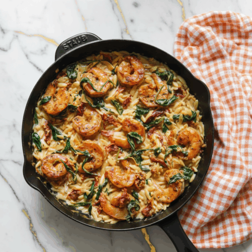 Shrimp Orzo Recipe with succulent pink shrimp, tender orzo pasta, fresh parsley and lemon wedges in white bowl