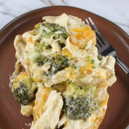 Creamy chicken divan crock pot with tender broccoli florets and melted cheese sauce ready to serve