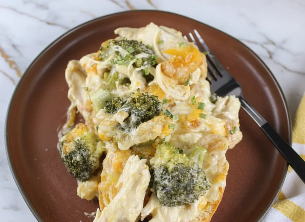 Creamy chicken divan crock pot with tender broccoli florets and melted cheese sauce ready to serve