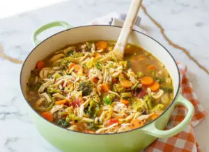 Detox southwest chicken soup with colorful peppers, corn, black beans, and tender chicken in a vibrant broth