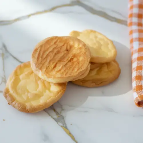 Fluffy cottage cheese cloud bread with golden edges cooling on wire rack showing airy texture and soft interior